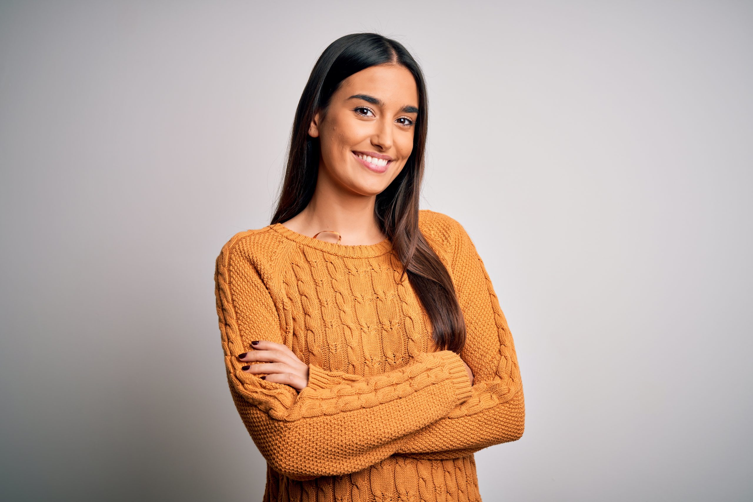 Young beautiful brunette woman wearing casual sweater over isola Woman is happy about her healthy relationship